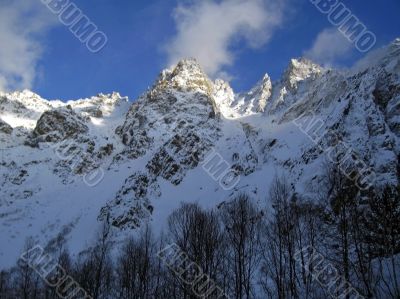 Mountain under the blue sky and the clouds