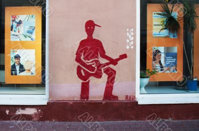 Drawing on a wall - the red guitarist