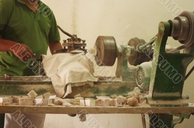 Craftsman using grinder in workshop