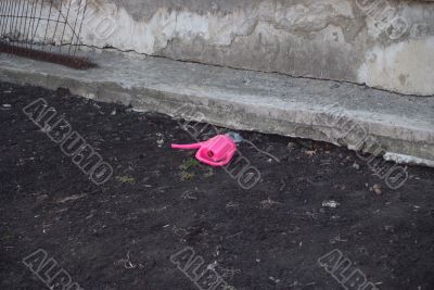 Early spring - a watering can on a ground