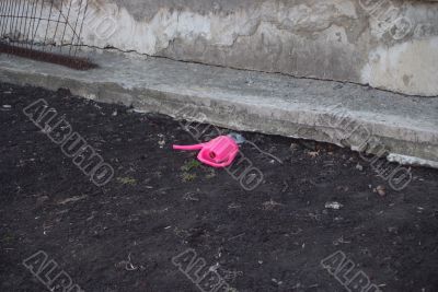 Early spring - a watering can on a ground Early spring - a watering can on a ground