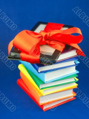 Electronic book reader tied up with red ribbon