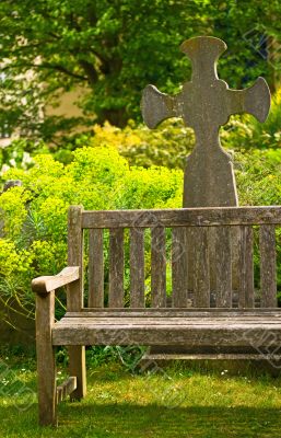 Rustical bench in blossom graveyard Rustical bench in blossom graveyard