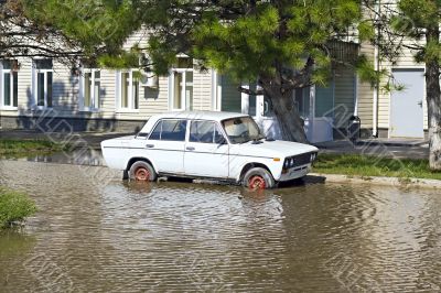 abandoned car in a deep pool near the building