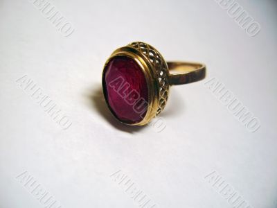 Golden ring with a red stone isolated