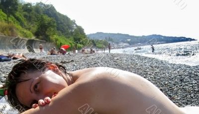 Woman laying on the seashore Woman laying on the seashore