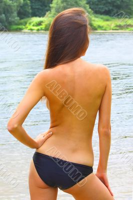 The young girl has a rest on a wood beach