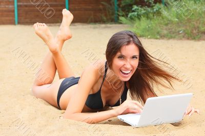 The young girl has a rest on a wood beach The young girl has a rest on a wood beach