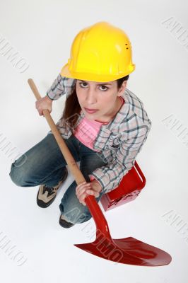 Female builder with a shovel