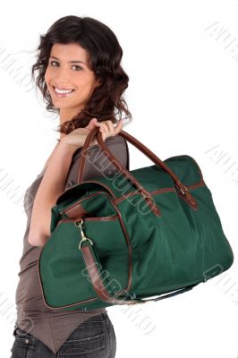Woman carrying a weekend bag over her shoulder