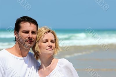 Couple stood together on a  beach
