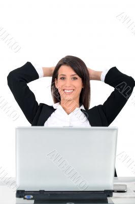 Business woman sat at desk in front of computer