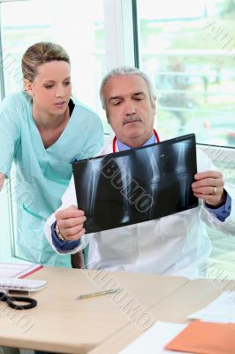 Doctor and nurse examining an xray