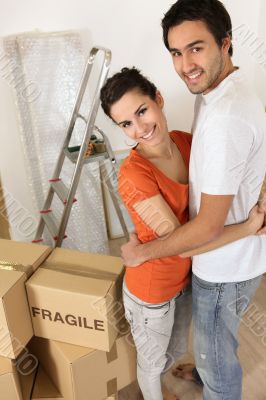Couple with packing boxes marked fragile