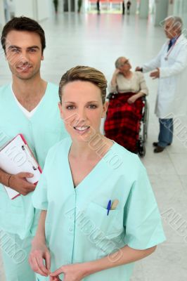 Nurses, doctor talking to a woman