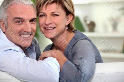 Smiling couple sitting on a sofa