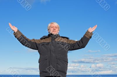 Middle-aged man on blue sky of the background.