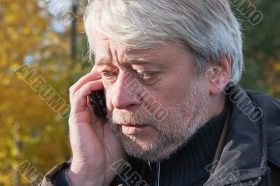 Portrair of mature middle-aged man in forest.