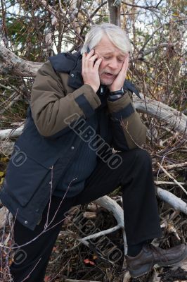 Mature middle-aged man in forest.