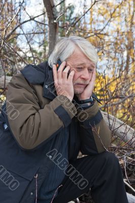 Mature middle-aged man in forest.