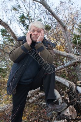 Mature middle-aged man in forest.