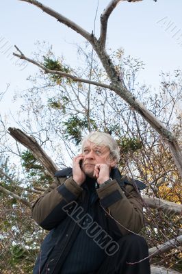 Mature middle-aged man in forest.