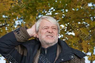 Portrait of middle-aged man in autumn day.