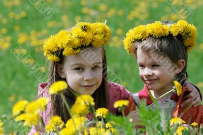 Brother and sister with dandelion garlands