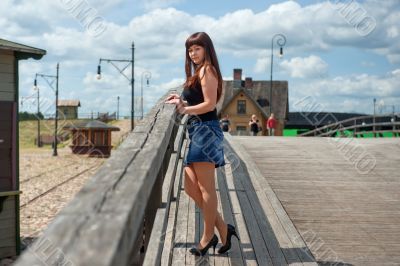 Beauty girl on the old-time bridge.