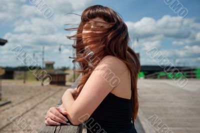 Beauty girl on the old-time bridge.