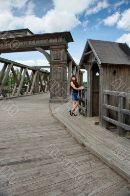 Beauty girl on old-time bridge.