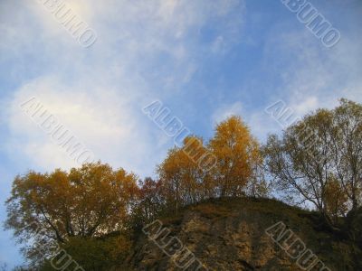 Golden autumn, blue sky and caucasus mountains