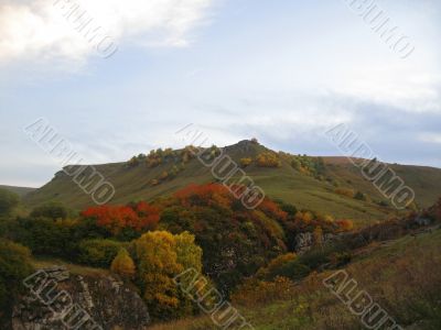 Golden autumn, blue sky and caucasus mountains