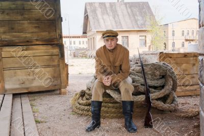 Retro style picture with soldier sitting on rope