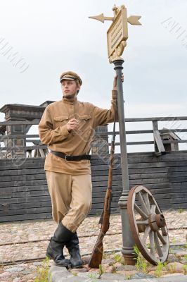 Retro style picture with soldier at tram stop.