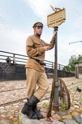 Retro style picture with soldier at tram stop.