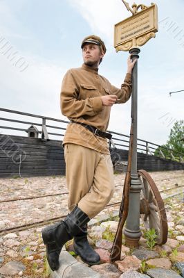 Retro style picture with soldier at tram stop.