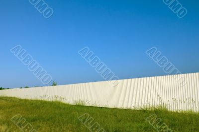 Long white metal fence