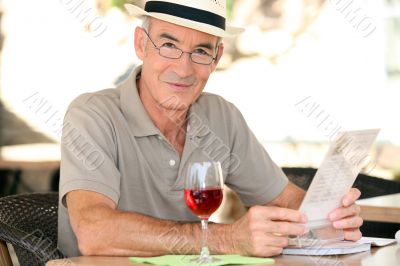 Retiree enjoying a glass of wine