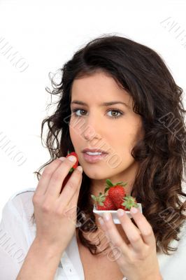 Woman eating strawberries