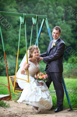 Bride and groom on swing