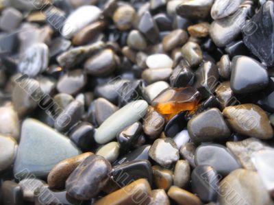 Orange glass laying on the sea shore