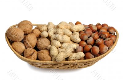 Set of nuts in a wicker basket, isolated