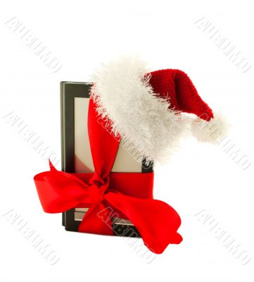 Electronic book reader wearing Santa`s hat