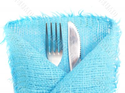 Knife, fork and a napkin on a white