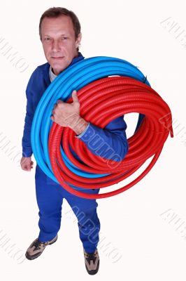 Studio shot of plumber with reels of tube