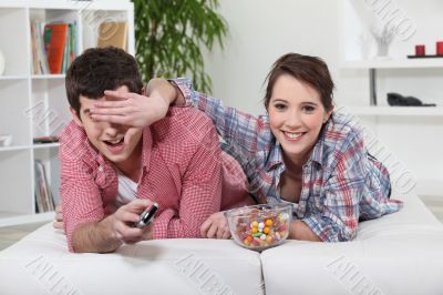 Young couple watching television