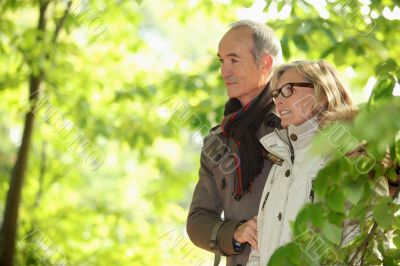 Older couple walking in the woods