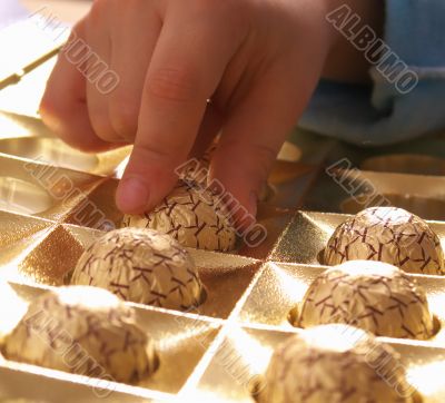Children's hands taking chocolate 