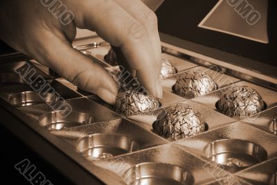 Woman's hand taking chocolate 